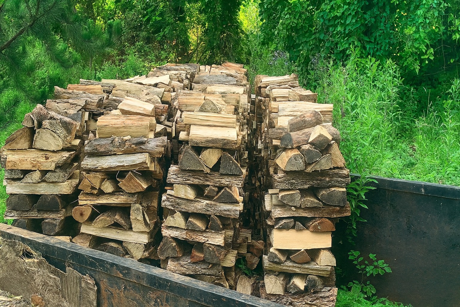 Neatly stacked seasoned firewood ready for delivery